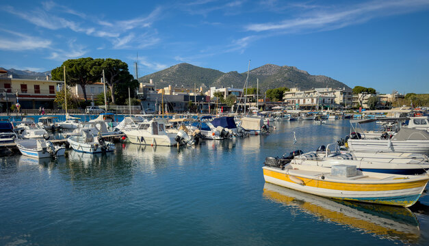 Nea Makri harbour, Attica Greece. Fishing boat moored in Aegean calm sea. Greek sun and blue sky.