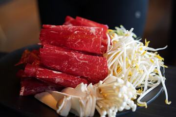 Raw red meat for shabu-shabu is thinly sliced and rolled into a round shape.
