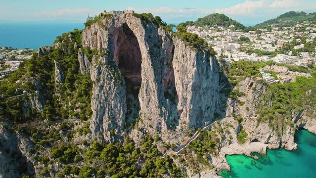 Capri Island Natural Grandeur The Iconic Arco Naturale. High rocky cliffs and deep blue sea in Italy. Popular tourist destination in summer.