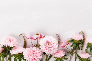Spring frame of small pink flowers and daisy, floral arrangement