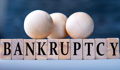 BANKRUPTCY - word on wooden blocks on dark blue background
