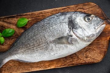 sea bream fish raw seafood tasty fresh healthy eating cooking appetizer meal food snack on the table copy space food background rustic keto or paleo diet Pescetarian