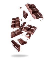 Crushed bar of dark chocolate in the air isolated on a white background