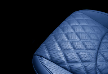Car blue leather interior. Part of orange leather car seat details with white stitching. Interior...