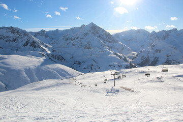 Fototapeta na wymiar Elevator to mountain peak. Snow slopes in Austria