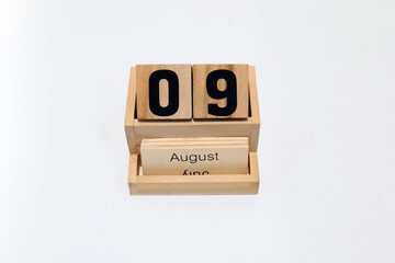 9th of August wooden perpetual calendar. Shot close up isolated on a white background