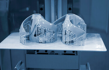 Printed models on 3D printer close-up. Objects printed on photopolymer sla 3D printer from liquid...