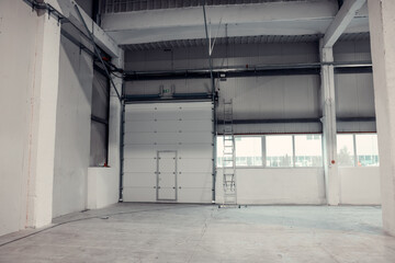 Roller door in a warehouse or factory. Industrial interior