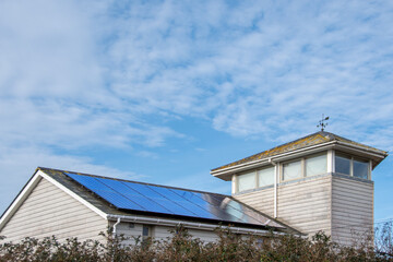 Solar panels on a domestic house roof. Clean renewable energy with zero carbon emissions....