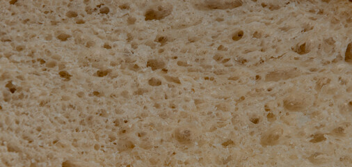 Macro closeup of a slice of loaf of freshly baked sourdough bread