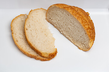 Sliced loaf of freshly baked sourdough bread with a shallow depth of field
