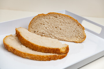 Sliced loaf of freshly baked sourdough bread with a shallow depth of field

