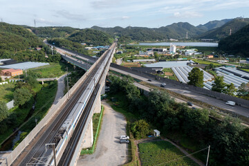 Scenery with highway and railroad tracks
