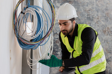 electrical engineers or technicians is professionally inspecting the wiring and systems in the...