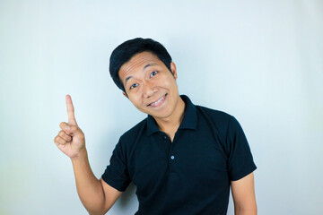 Asian man expression smiling while pointing to the side presenting the product. advertising concept
