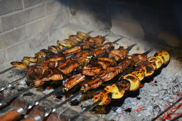 Obraz na płótnie Canvas Meat skewers grilling over hot barbecue coals