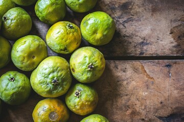 a group of limes on a table - obrazy, fototapety, plakaty