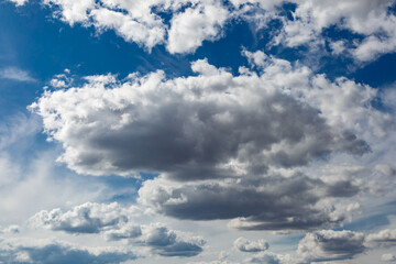 White fluffy clouds and bright sun on dark blue sky.Sky blue or azure sky and clouds is bright white background.