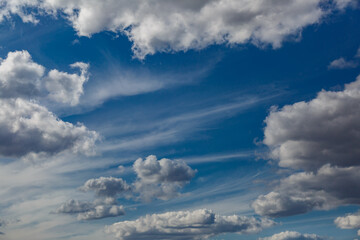 Obraz premium White fluffy clouds and bright sun on dark blue sky.Sky blue or azure sky and clouds is bright white background.