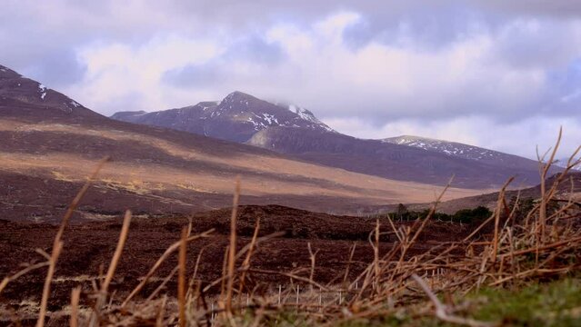 View of beautiful countryside in the Scottish highland with mountains, trees and sea