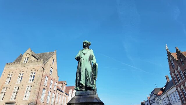 Statue on the Van Eyck square in the city of Bruges in Belgium