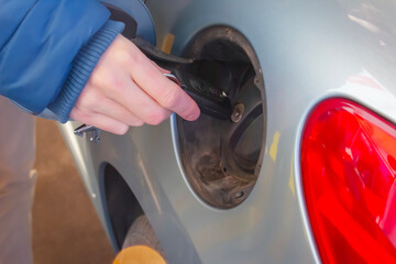 Refueling the car at a gas station fuel pump.