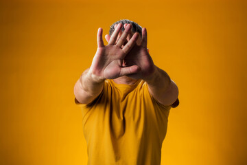 Man in fear showing stop gesture. People and emotion concept