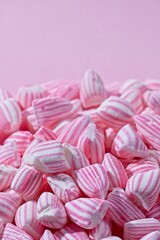 Close up vertical view of pink and white striped candy with copy space and selective focus