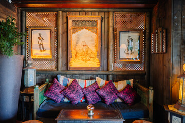 Sotogrante, Spain - January 25, 2024 - An exotic lounge with colorful cushions, wood paneling, and...