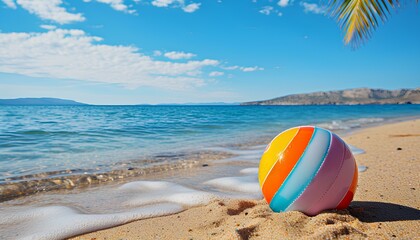 Obraz premium beach ball on a tropical sandy beach during summer. Beach ball in sand. Summertime vacation with clear blue water and the sun