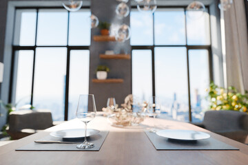 closeup of dining table in luxurious loft apartment with floor-to-ceiling windows and panoramic view; modern minimalistic interior design; bright daylight; 3D rendering
