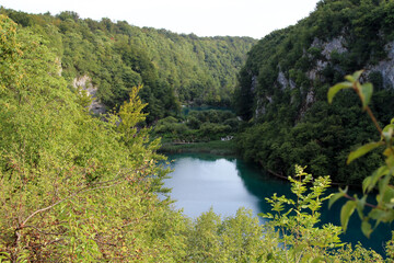 Fototapeta na wymiar Azure Crystal Clear Water Of Lake. Lake Trails. Lake Hikes. Area of Outstanding Natural Beauty. Plitvice Lakes National Park