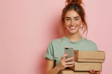 Young happy woman wear green shirt white t-shirt hold in hand brown clear blank craft stack cardboard boxes mock up use mobile cell phone isolated on plain pastel light pink background - obrazy, fototapety, plakaty