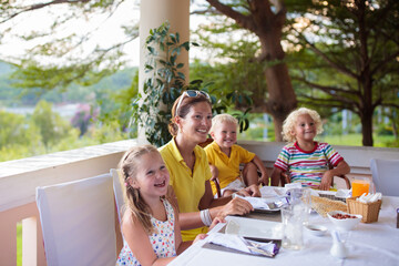 Family having dinner on outdoor patio.