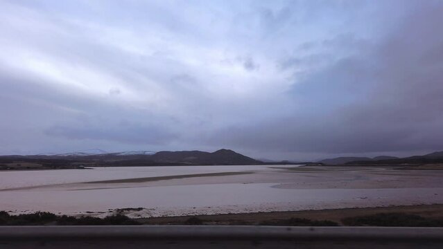 Car point of view, POV driving along a landscape and scenery through beautiful roads in the Scottish highland.