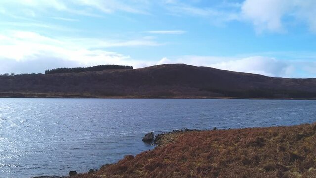 Car point of view, POV driving along a landscape and scenery through beautiful roads in the Scottish highland.