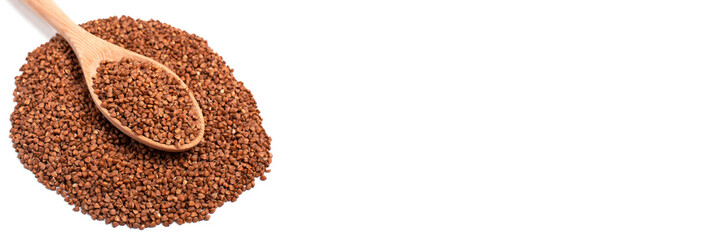 Dry buckwheat in wooden spoon isolated on white background. Banner.