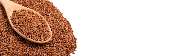 Dry buckwheat in wooden spoon isolated on white background. Banner.