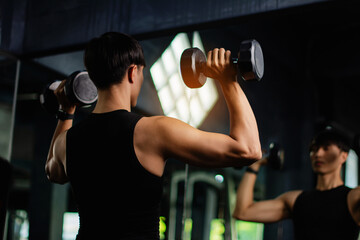 Lifting dumbbell exercises builds strong upper arm muscles. Exercise activities for health lovers...