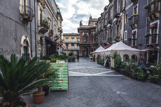 Catania, Italy - December 16, 2016: Restaurants on Via Michele Rapisardi street and Teatro Massimo Bellini opera house in Catania city