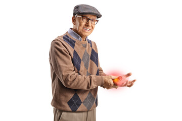 Elderly man in pain holding his inflamed red hand wrist