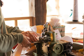 Female hands sewing with modern sewing machine at work Sewing process, DIY repairs, handmade,...