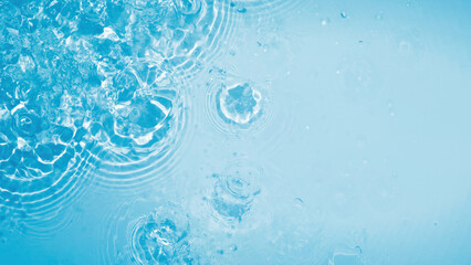 abstract blue whirled water surface from above with splashes and sun lights, water texture concept...