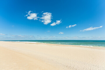 Fototapeta na wymiar Topsail Island beach with warm sand and blue skies.