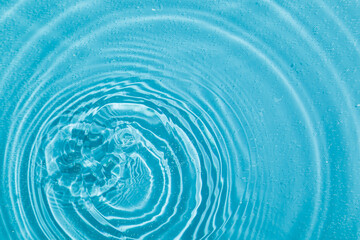 drops on water with circles on a blue background