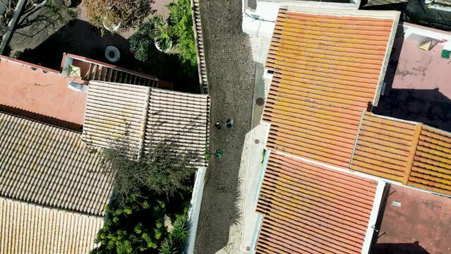 Hill town of Silves, Algarve, Portugal during spring, cobbled streets and orange roofs by 4K drone