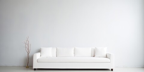 White couch in a bright room, blending with the background.
