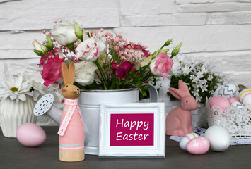 Easter greeting card: bouquet of flowers, Easter bunny and Easter eggs with the text Happy Easter.