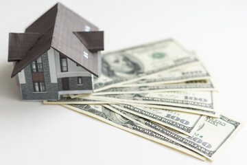 Small Model House on Layer of One Hundred Dollar Bills.