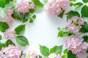 A captivating arrangement of delicate pink flowers encircled by a lush frame of green leaves
